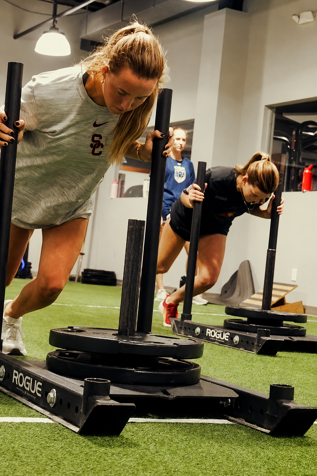 Female athlete performing a sled push at Overdrive